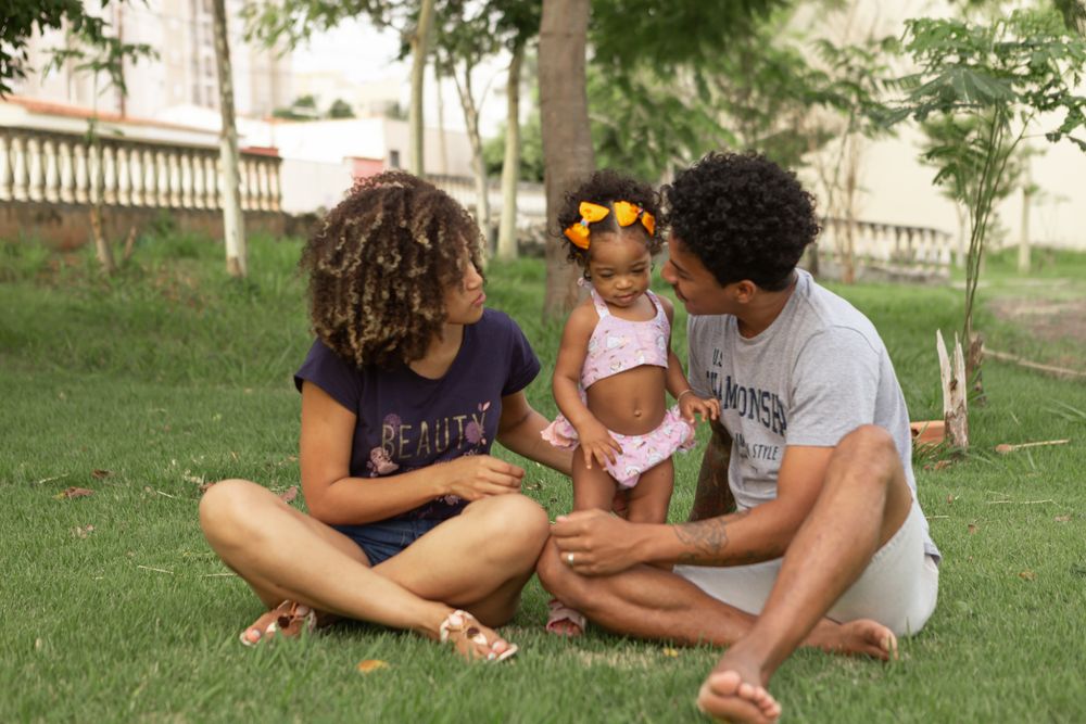 A family sharing a relaxed afternoon together on a sunny lawn